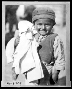 Fresh clean clothing - is welcomed by this youngster jud(g)ing by his expression He is one of the young members of the camp of Greeks from the Caucasus brought back to colonize the rewon LCCN2010648490