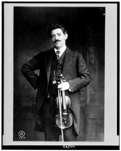 Fritz Kreisler, three-quarter length portrait, standing, facing slightly left, holding violin and bow LCCN91794749