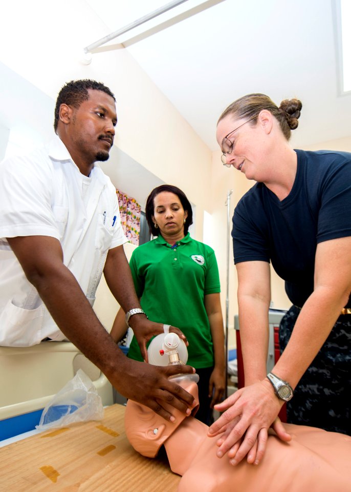 From left, Kevin Dawson, a rural health nurse, and Lissette Recinos, a public health nurse, conduct a subject matter expert exchange on advanced cardiac life support with U.S. Navy Lt. Cmdr. Suzanne Maldarelli 140627-N-XQ474-076