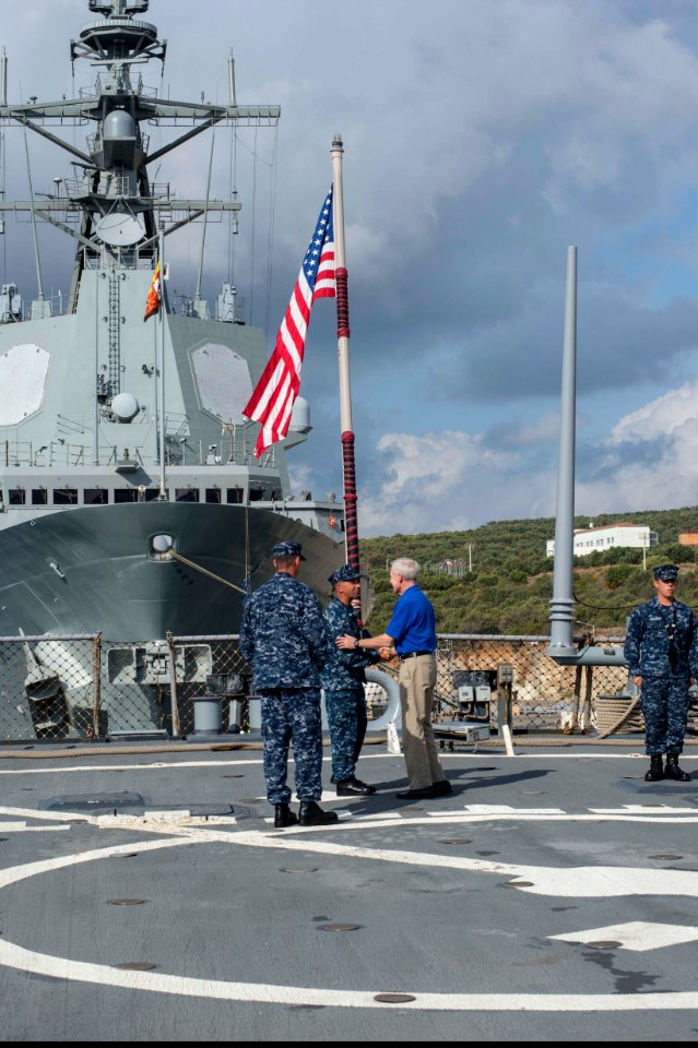 From left, U.S. Navy Cmdr. Dave Stoner, the commanding officer of the guided missile destroyer USS Ramage (DDG 61), and Command Master Chief Joseph O'Brien, the Ramage's command master chief, welcome 131115-N-VC236-013