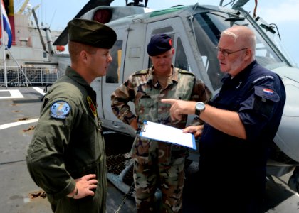 From left, U.S. Marine Corps Staff Sgt. Scott D. Schamber, left, assigned to Marine Light Attack Helicopter Squadron (HMLA) 773; Royal Netherlands Marine Corps Sgt. Maj. Arthur F. Van Hofwegen; and Royal 130926-N-CH661-106