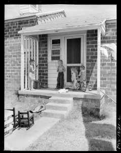 Front porch of home of government housing project now partially occupied by oil field workers. McCurtain, Le Flore... - NARA - 540650
