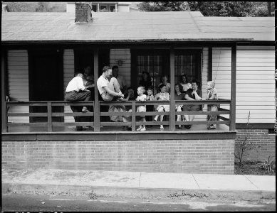 Front porch of the Harry Fain home on Sunday afternoon. Relatives and other company are frequent Sunday visitors.... - NARA - 541434