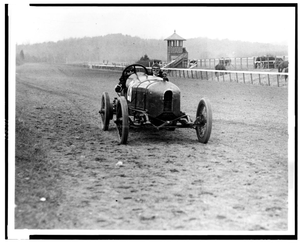 Front view of man and woman riding in Stutz Weightman Special no. 26 on Benning race track, Washington, D.C., area LCCN90710633