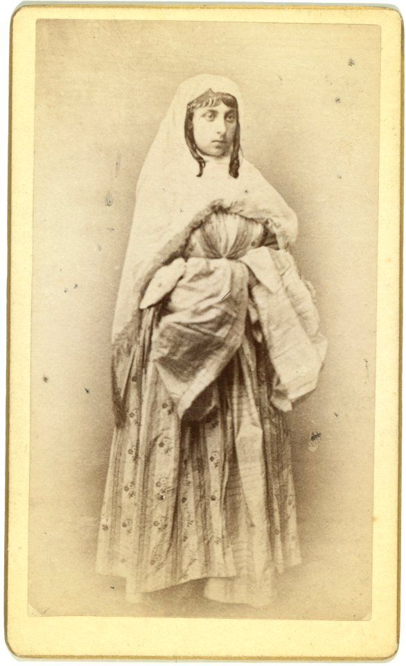 Full-length portrait of a woman, facing slightly right, in traditional dress LCCN99615602