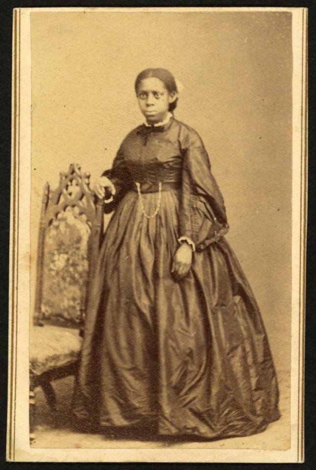Full-length portrait of an unidentified African American woman, standing beside a chair) - photographed by William Abel, Flamington, N.J LCCN2010647809