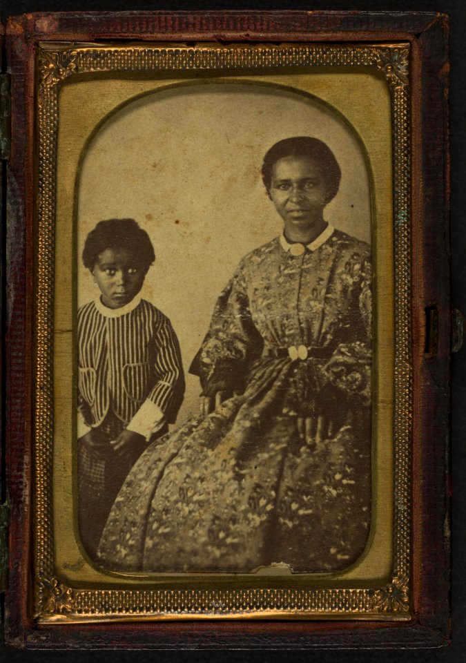 Full-length portrait of an unidentified woman, seated, and full-length portrait of a child standing on her right, both subjects are facing front LCCN2002719399