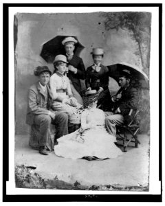 Full-length group portrait of five women, three dressed in men's clothing LCCN2006689632