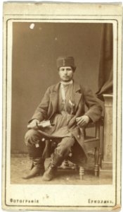 Full-length portrait of Persian man, seated, facing front LCCN99615599