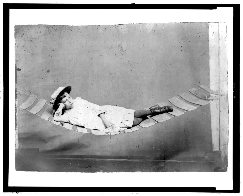 Full-length portrait of a young girl reclining in a hammock LCCN2006689574