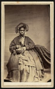 Full-length portrait of an African American woman holding a basket LCCN2010647799