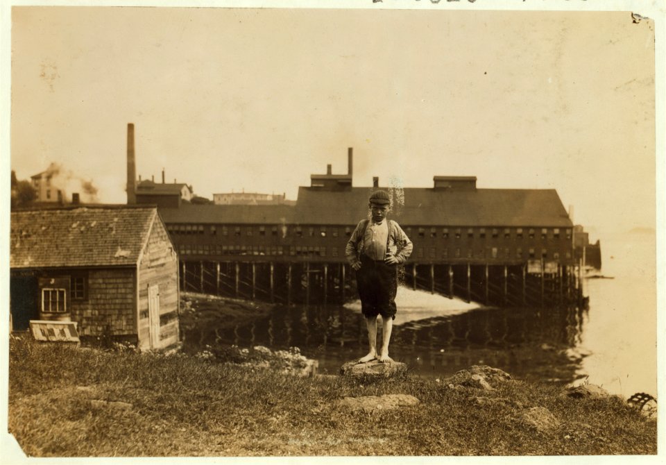Fulsom McCutcheon, 11 years old, has been working at the covering machines in Eastport canning factory, also cutting some. In the background is a typical sardine factory. LOC cph.3b37904