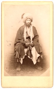 Full-length portrait of man, seated, facing front LCCN99615641