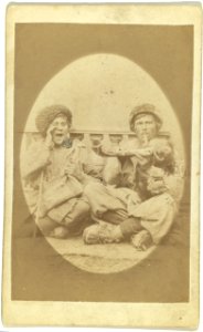 Full-length portrait of two men, seated, one playing an instrument LCCN99615605