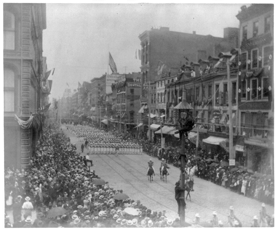 Funeral of Pres. Grant, New York City- groups of men marching in backgrd.; 3 men in light pole in foregrd. LCCN2003677343