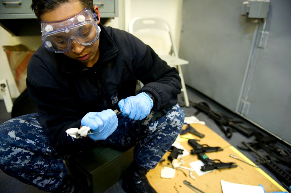 Future USS America armory sailors clean weapons 140814-N-MZ309-052