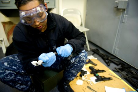 Future USS America armory sailors clean weapons 140814-N-MZ309-052