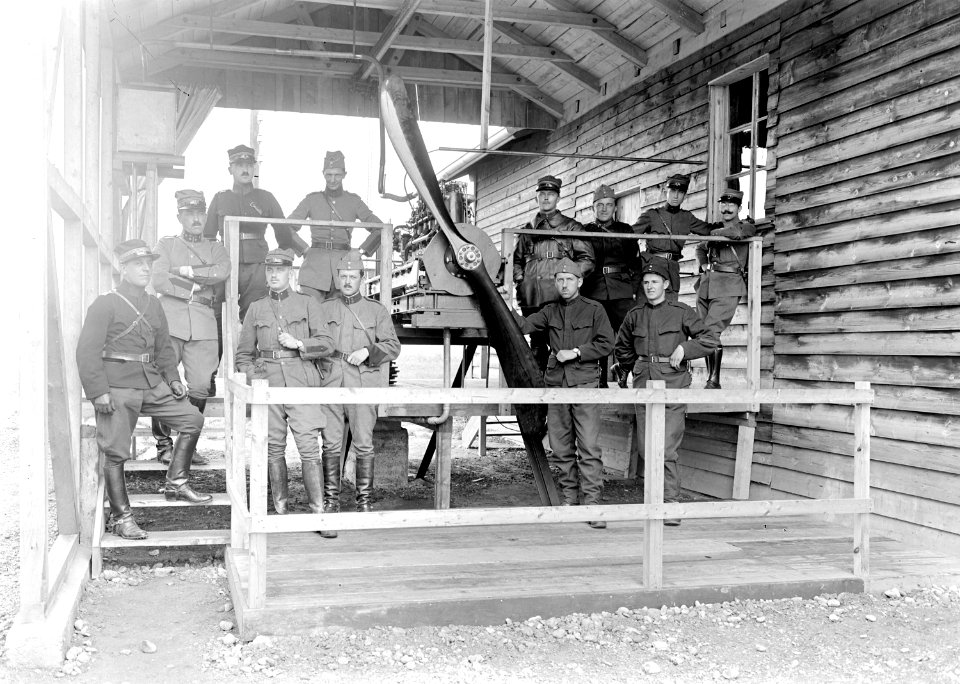 Gruppenbild von Angehörigen der Fliegertruppen vor einem Flugzeugmotor - CH-BAR - 3240099