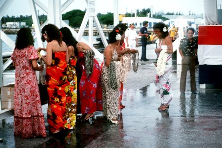 Guamanian women wait at Naval Station Guam to welcome the crew of the combat stores ship USS NIAGARA FALLS DN-ST-85-11068