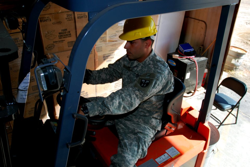 Guard prepares to deliver supplies using a fork lift
