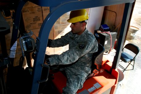 Guard prepares to deliver supplies using a fork lift