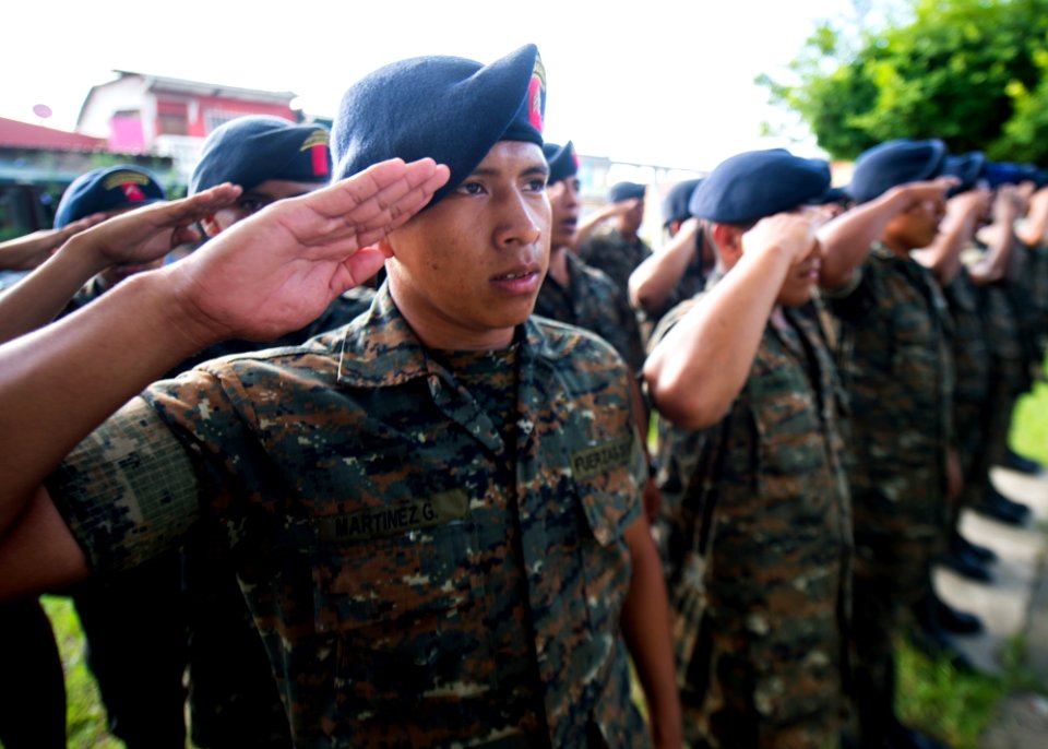 Guatemalan service members salute during a ceremony at the city library in Puerto Barrios, Guatemala, Aug. 21, 2014, during Southern Partnership Station (SPS) 2014 140821-N-XQ474-172
