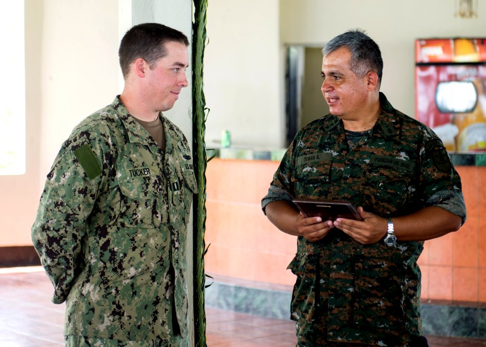 Guatemalan Ship's Capt. Saul Arnoldo Tobar Garcia, right, the second in command of the Guatemalan Marine Brigade, presents a gift of appreciation to U.S. Navy Lt. Sean Tucker, assigned to Coastal Riverine 140822-N-XQ474-219