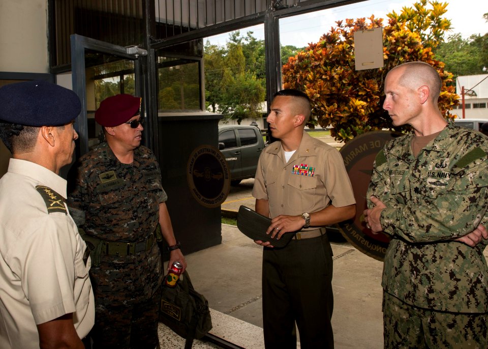 Guatemalan Naval Infantry Force Coronel Medardo Monterroso Suarez speaks with Coronel de Infanteria Ronal Herman Velasquez Sosa, U.S. Navy Cmdr. Jeffrey V. Morganthaler, right, the commanding officer ashore 140808-N-QY430-001