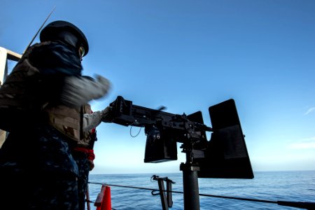 Gunner's Mate aboard USS Anchorage (LPD-23) reloading .50-caliber machine gun during live-fire exercise 150319-N-BD107-122