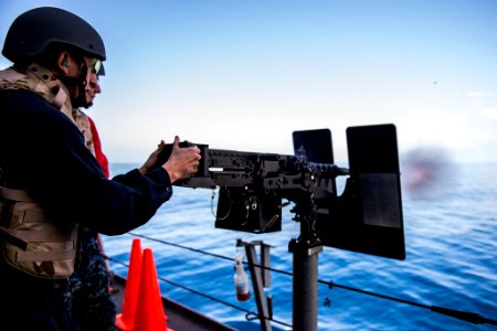 Gunner's Mate aboard USS Anchorage (LPD-23) firing .50-caliber machine gun during live-fire exercise 150319-N-BD107-236