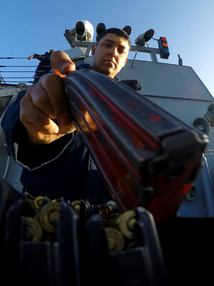 Gunner's Mate loading M16 magazines during small arms firing aboard USS Carney (DDG-64) 160211-N-FP878-346
