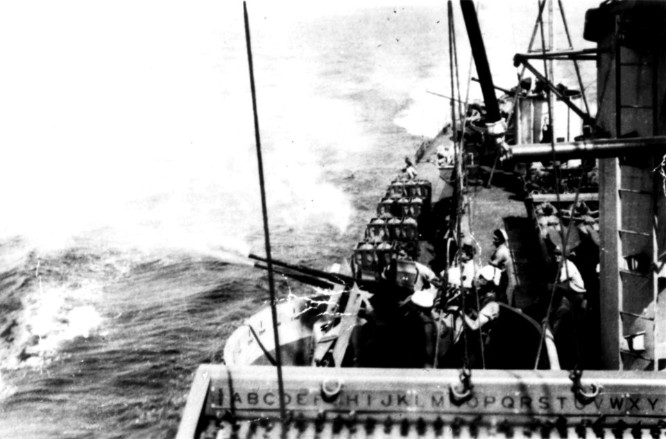 Guns firing aboard USS Riley (DE-579), in 1945 (NH96720)