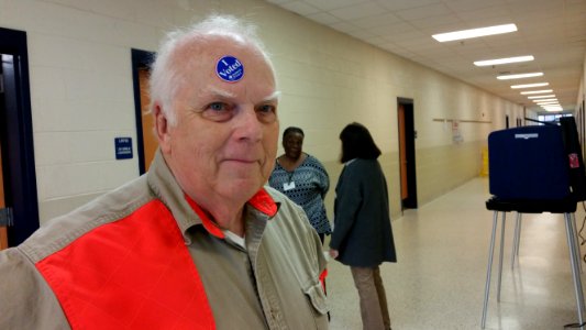 Hal Marshall playfully displays his commitment to voting after casting a ballot at Charleston's Burke High School in South Carolina's Republican primary, Feb. 20, 2016. Marshall says he voted for the big guy, Donald Trump