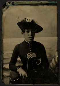 Half-length portrait of an African American woman wearing a hat and holding parasol LCCN2010650827