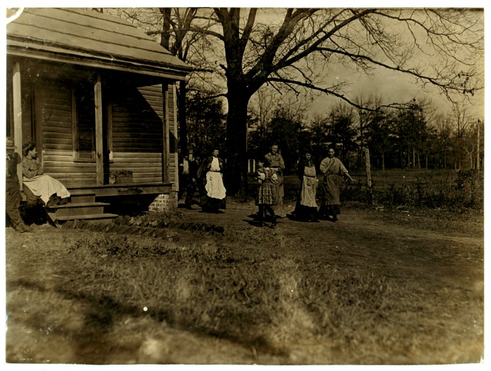 Hands going home from Atherton Mill, Charlotte, N.C. Little girl came from the mill. Evidently a 'helper.' I saw others about her size in the mill spinning. LOC nclc.01565