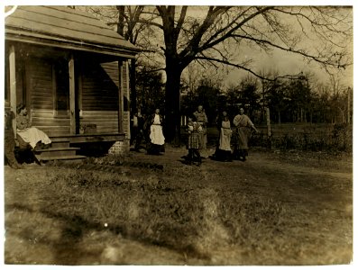 Hands going home from Atherton Mill, Charlotte, N.C. Little girl came from the mill. Evidently a 'helper.' I saw others about her size in the mill spinning. LOC nclc.01565