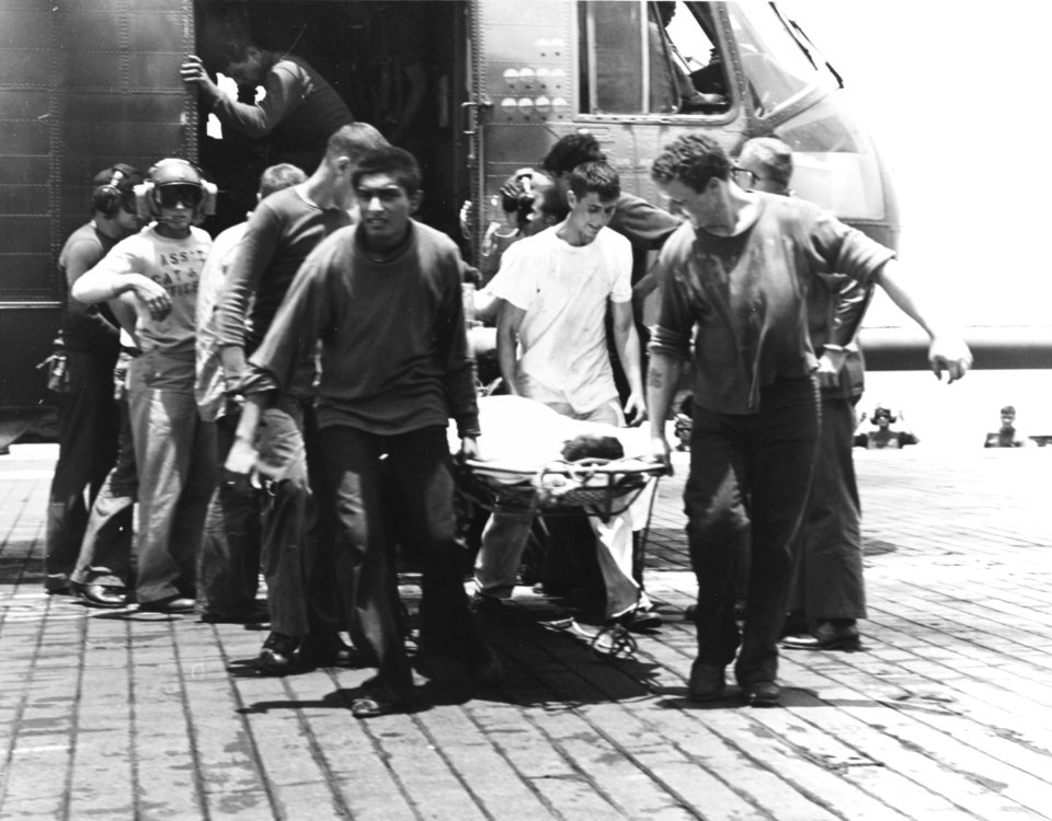 Injured crewman from USS Forrestal (CVA-59) is brought to USS Oriskany (CVA-34) with USAF HH-3E in 1967