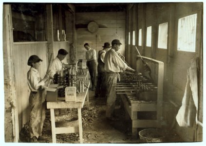 Interior of workshop of Sanitary Ice Cream Cone Co. See 4830. Boys packing cones are John Myers, 14 years old and a boy 12 years old who is working steady now. Boss said- 'He said he wasn't LOC nclc.05241