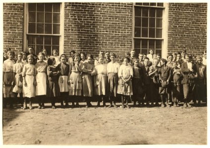 Investigator saw all the children in this photograph coming out and going in to work when the whistle blew, and they said they worked. Lumberton Cotton Mills. LOC nclc.02960