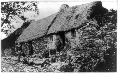 Irish family in front of peasant house with thatched roof, Ireland LCCN2017656338 photo