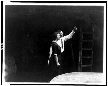 Irène Joliot-Curie, three-quarter length, facing right, with a man, at Standard Chemical Company LCCN92509319
