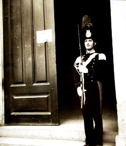 Italian national policeman on guard outside an Allied military government office, Sicily, 1943 (23933646594)