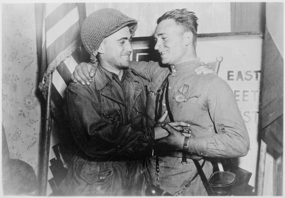 Happy 2nd Lieutenant William Robertson and Lt. Alexander Sylvashko, Russian Army, shown in front of sign (East Meets... - NARA - 531276