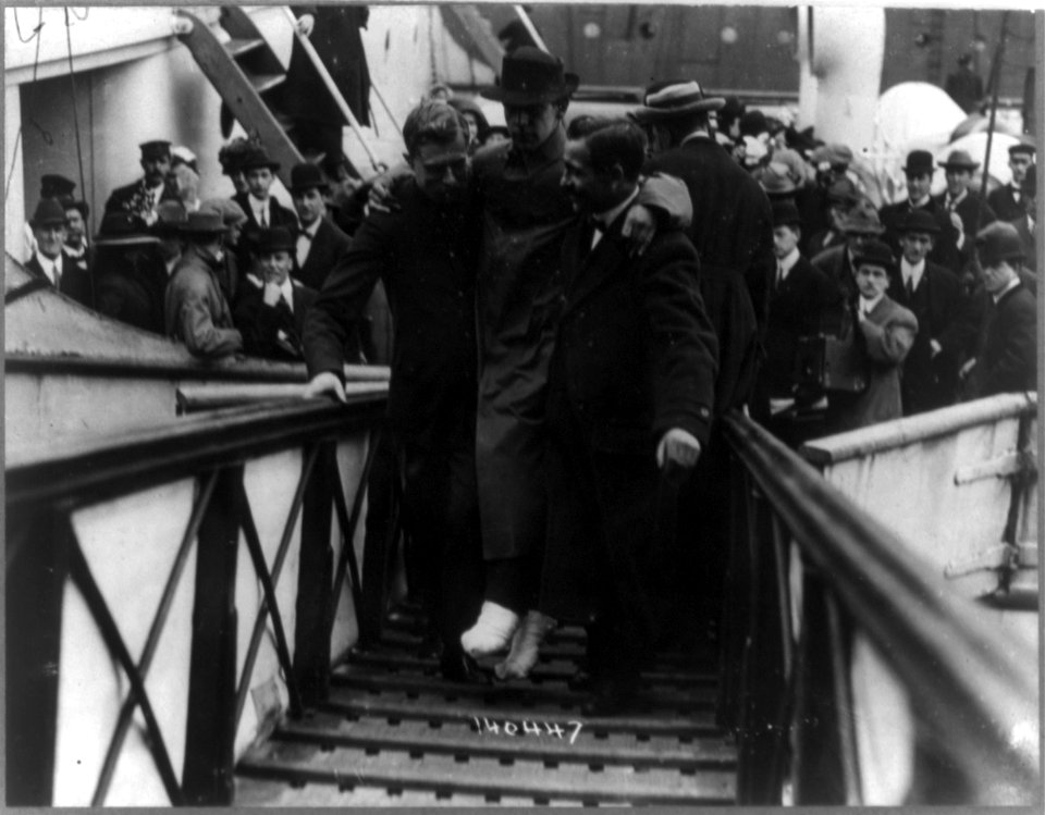 Harold Bride, surviving wireless operator of the TITANIC, with feet bandaged, being carried up ramp of ship LCCN2002714434