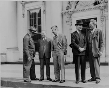Harold L. Ickes, Henry A. Wallace and three other men standing in front of the White House during ceremonies... - NARA - 199082