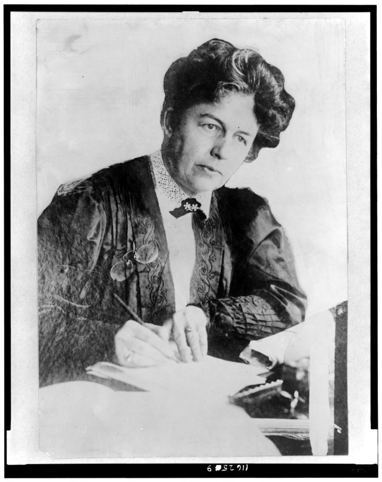 Harriot Stanton Blatch, half-length portrait, seated, facing slightly right, writing LCCN96509180