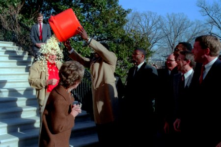 Harry Carson dumping popcorn on President Ronald Reagan
