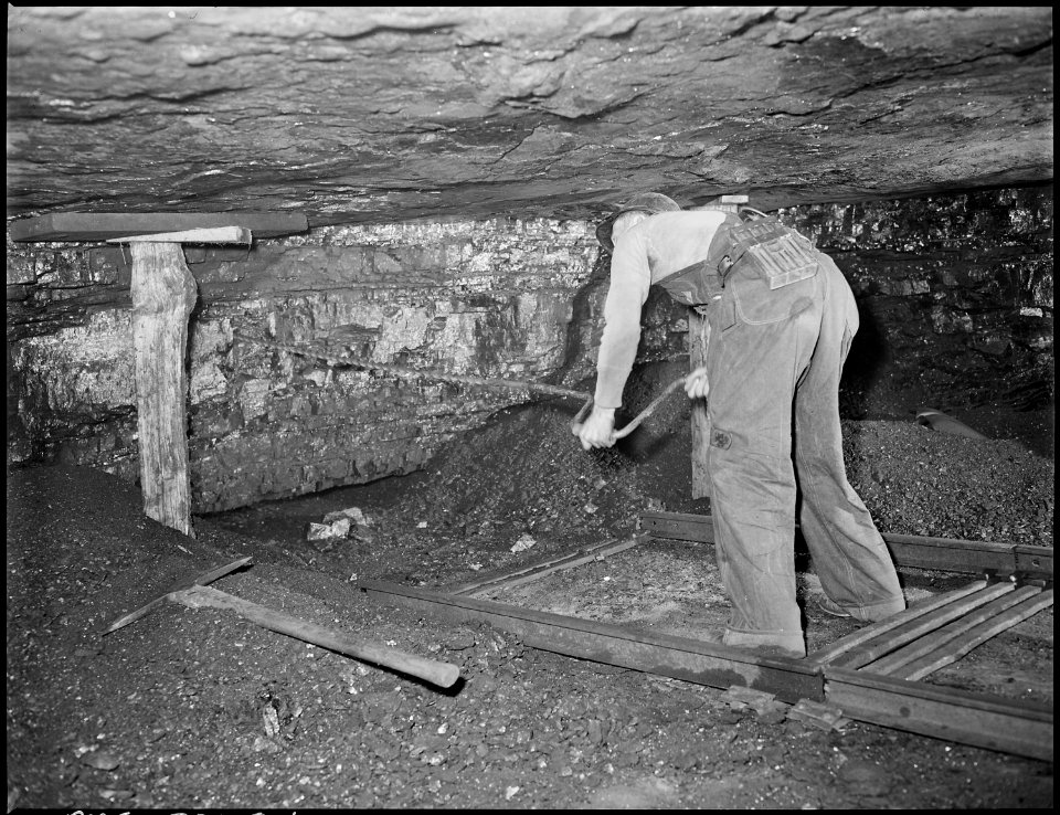Harry Fain, coal loader, drills coal with hand auger. Powder charges are then placed and ignited. Inland Steel... - NARA - 541482