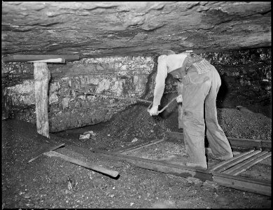 Harry Fain, coal loader, drills coal with hand auger. Powder charges are then placed and ignited. Inland Steel... - NARA - 541482