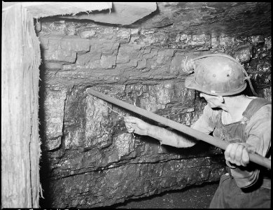 Harry Fain, coal loader, tamping the powder charge preparatory to ignition. Inland Steel Company, Wheelwright ^1 & 2... - NARA - 541477